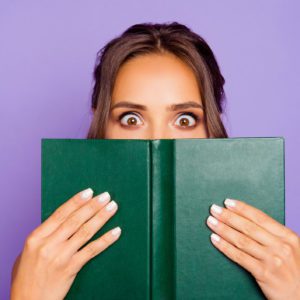 Girl Covering Her Face with a Book