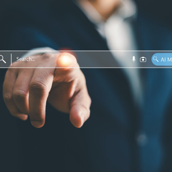 A man in a suit with his finger touching a search bar